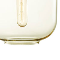 Clear glass container with a smooth, round base and subtle yellow tint. Elegant, modern design.