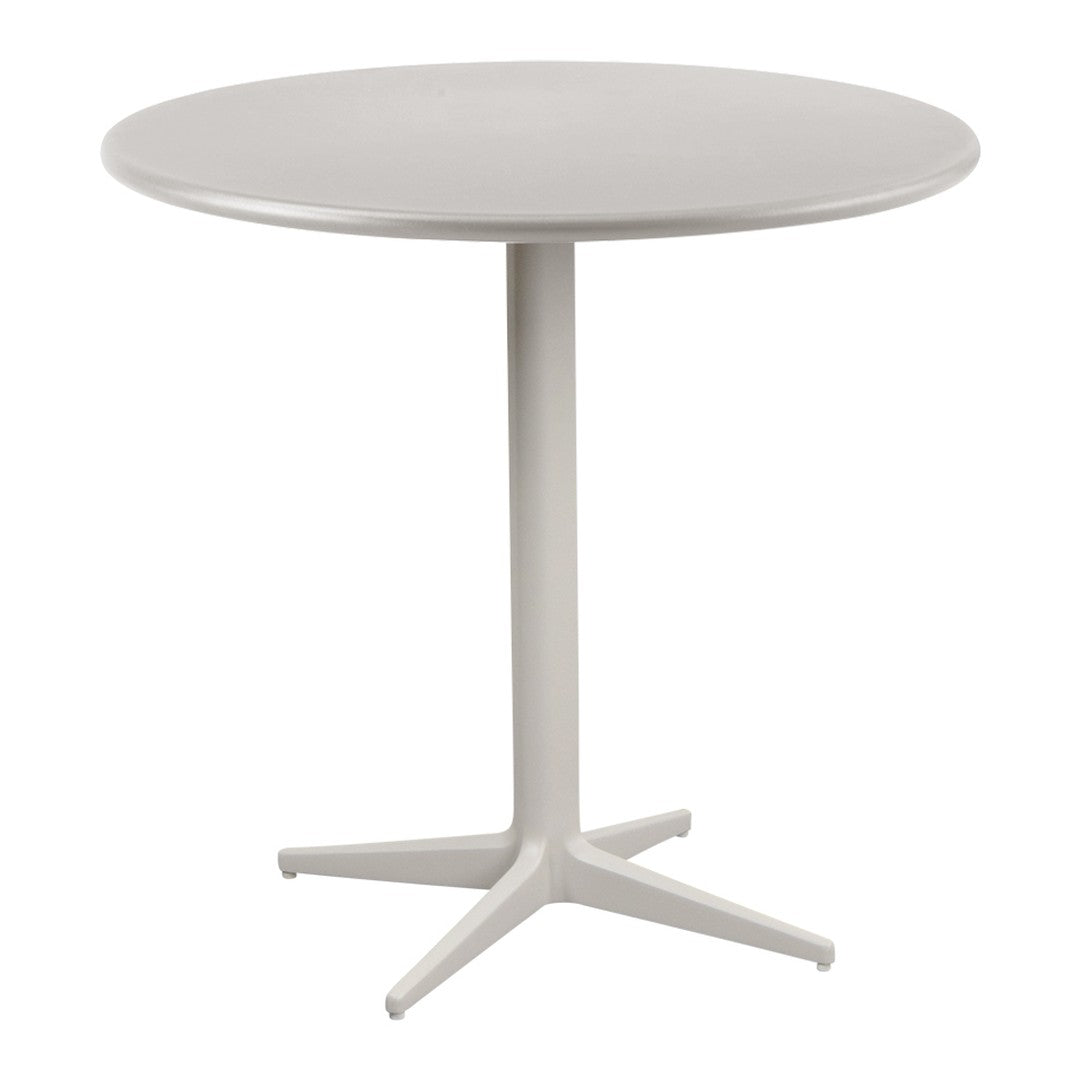 Round white dining table with a smooth surface and sleek base, perfect for modern interiors.
