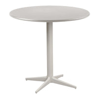 Round white dining table with a smooth surface and sleek base, perfect for modern interiors.