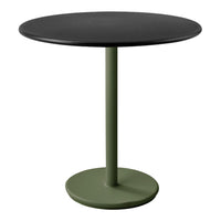Round table with a sleek black top and matte green base, featuring a minimalist design. Perfect for modern decor.