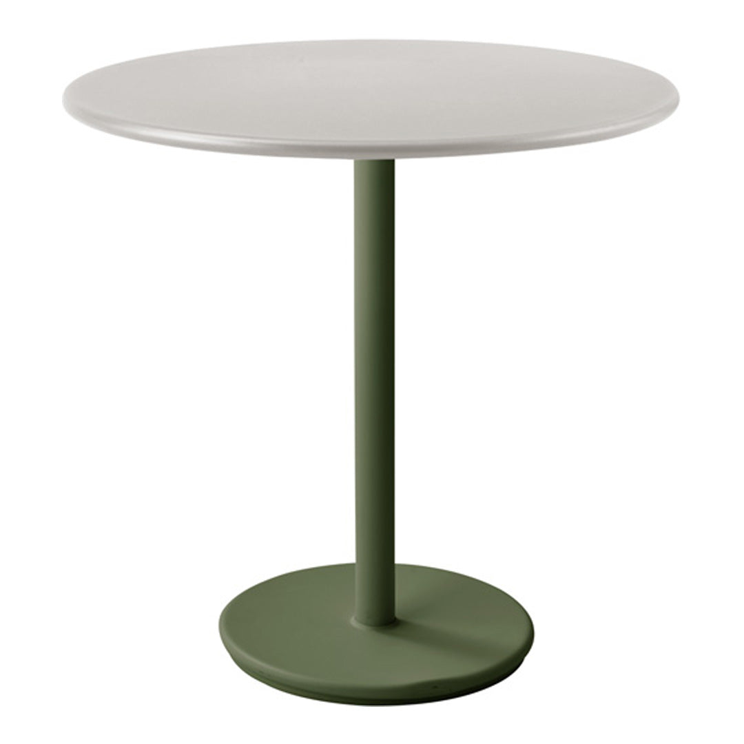 Round table with a smooth white top and a stylish green pedestal base. Modern and minimalist design.