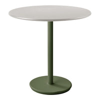 Round table with a smooth white top and a stylish green pedestal base. Modern and minimalist design.