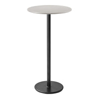 Minimalist round table with a sleek white top and matte black base, perfect for modern decor.