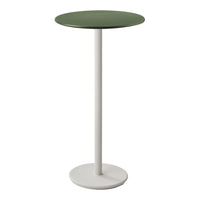 Green circular tabletop on a sleek white pedestal base, modern minimalist design for contemporary settings.
