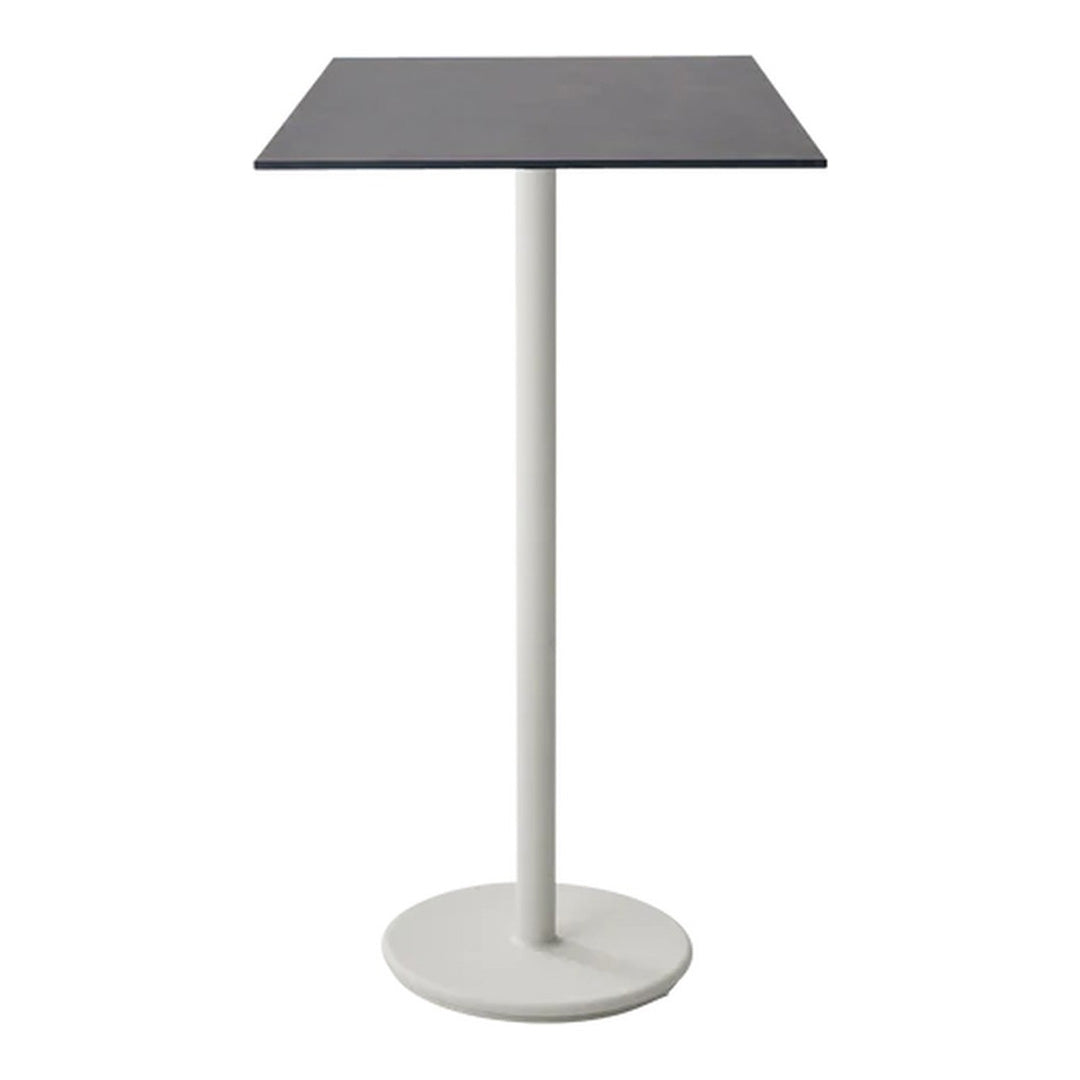 Stylish black tabletop with a sleek white pedestal base, perfect for modern spaces.