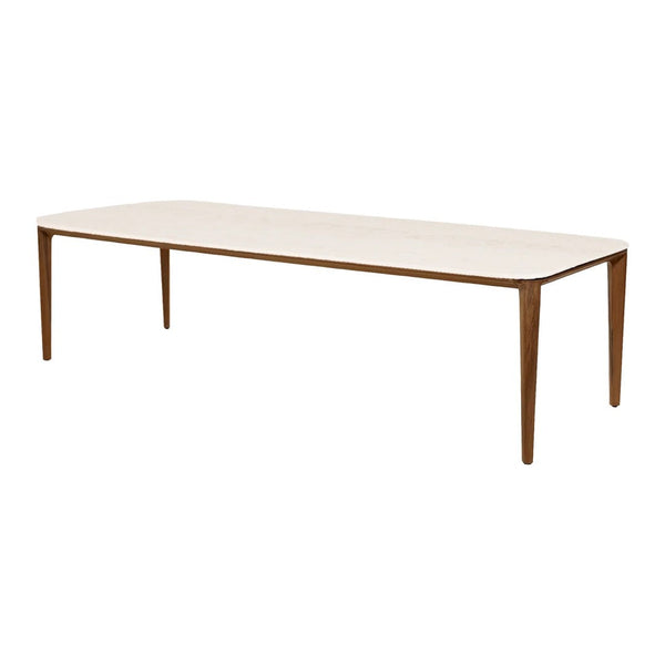 Long rectangular table in a light wood finish with tapered brown legs and a smooth beige surface.