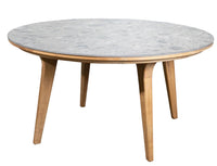 Round table with a gray marble top and natural wood legs, showcasing a sleek, modern design.