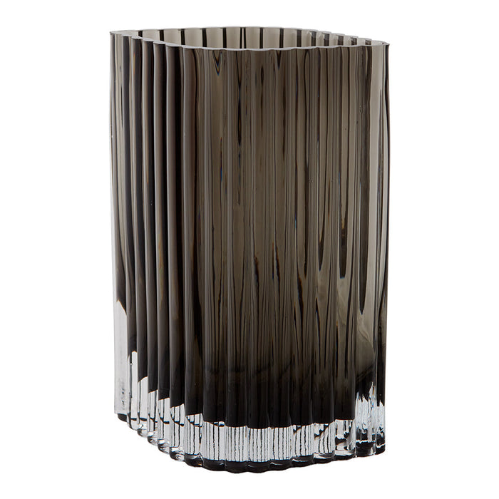 Smoky gray glass vase with vertical ribbed pattern and crystal clear base. Elegant home decor piece.