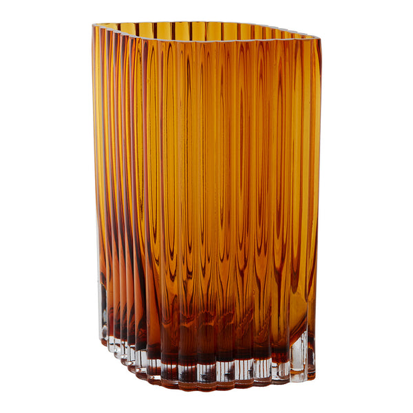 Amber glass vase with vertical ribbed texture and a clear base. Elegant, modern design in warm tones.