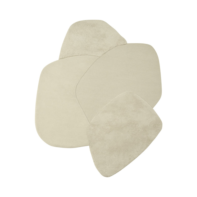 Neutral beige area rug set in organic shape, featuring soft textures and subtle variations, perfect for modern decor.