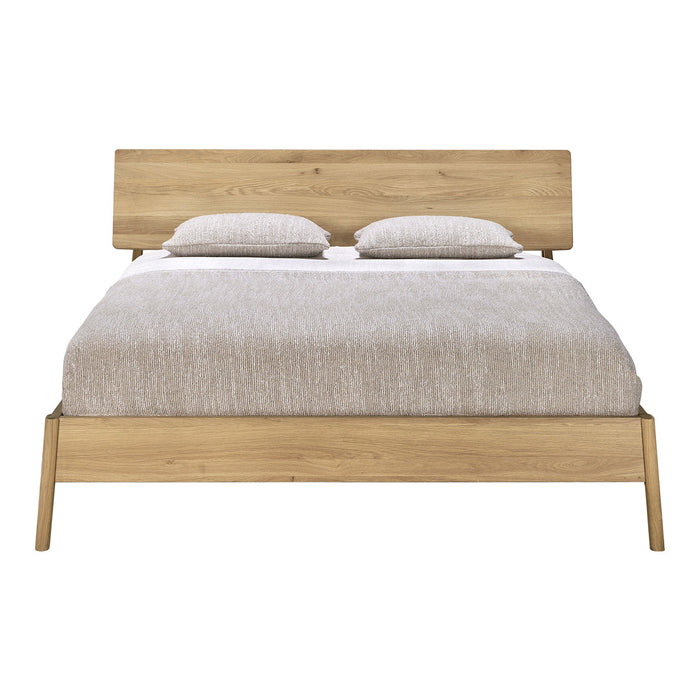 Light beige bed with textured bedding and natural wood frame featuring clean lines and a minimalist design.