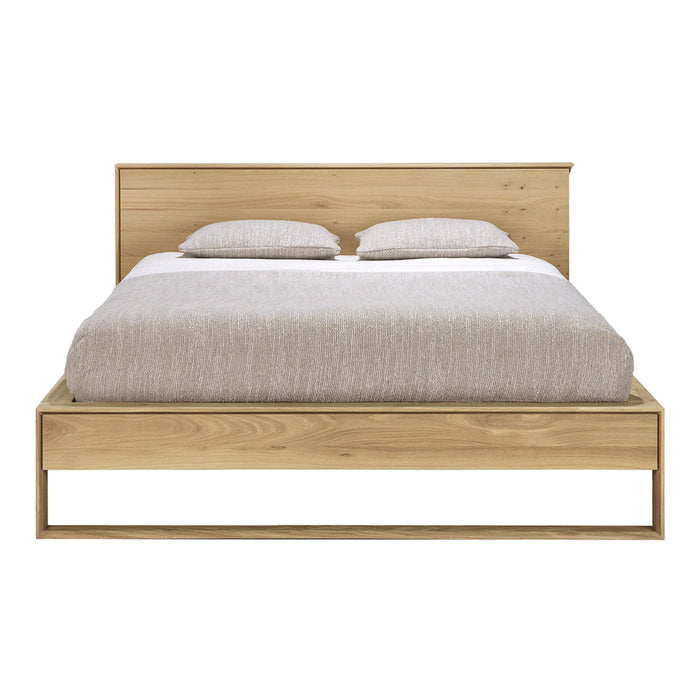 Light wood bed frame with a clean design, featuring a beige bedding set for a modern, minimalist aesthetic.