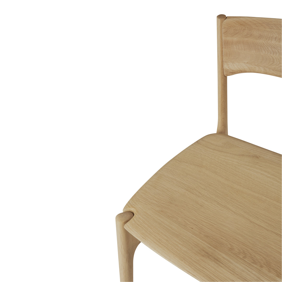 Natural wood color chair with smooth surface and minimalist design, highlighting light oak hues and clean lines.