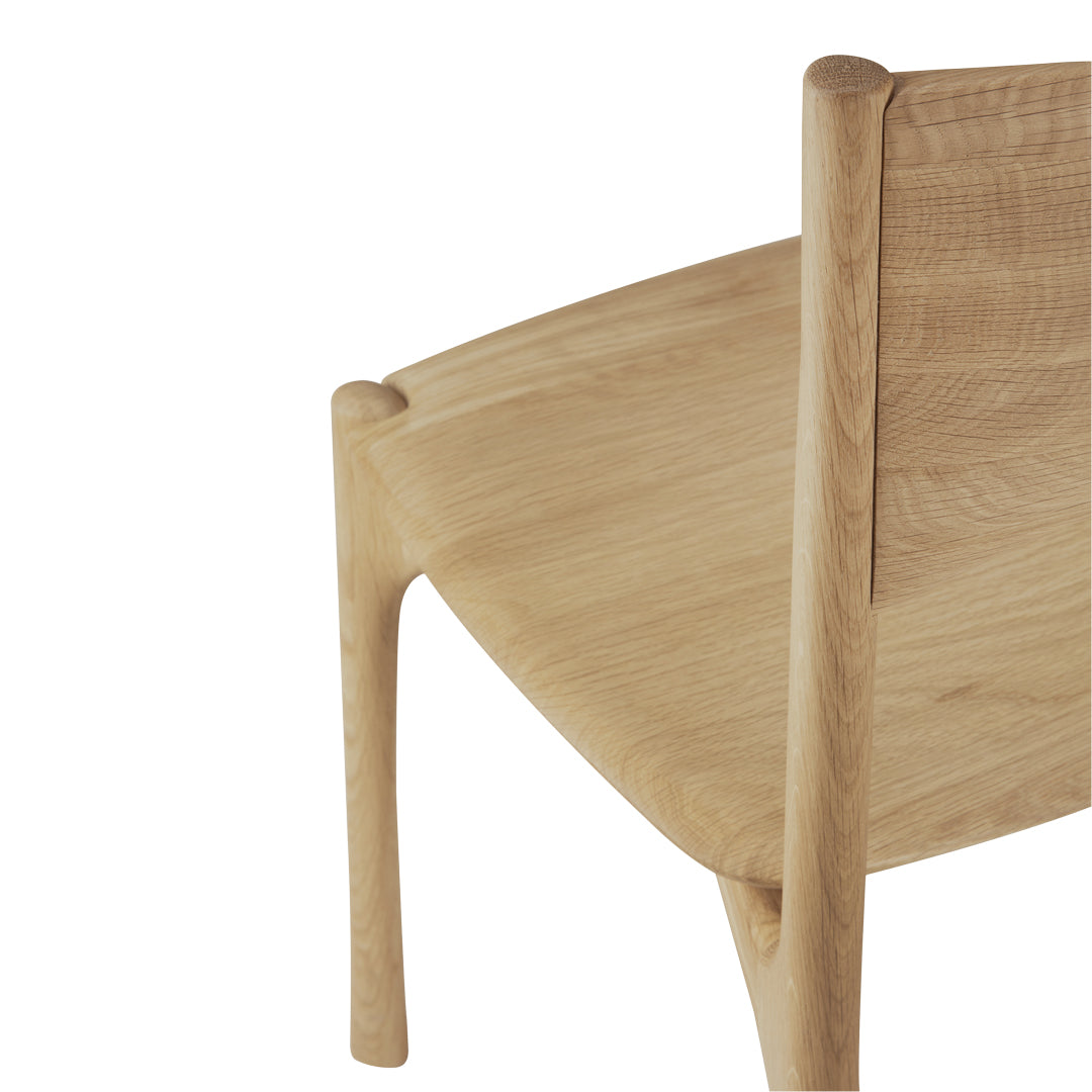 Natural wood chair with a smooth light oak finish and minimalistic design, showcasing clean lines and subtle textures.