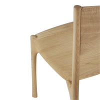 Natural wood chair with a smooth light oak finish and minimalistic design, showcasing clean lines and subtle textures.