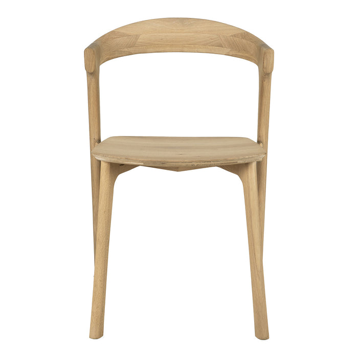 Natural wood chair with a light oak finish and smooth, minimalist design. Perfect for modern decor.