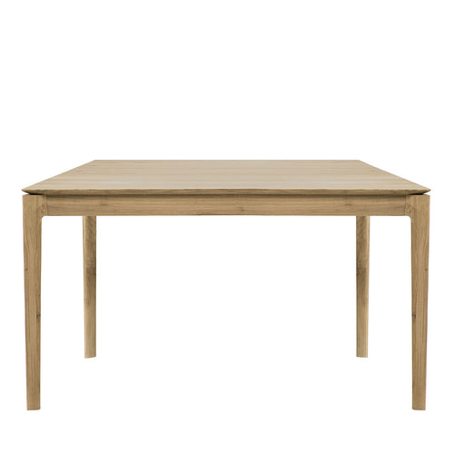 "Stylish square wooden dining table in light natural wood finish with smooth, minimalistic surface."