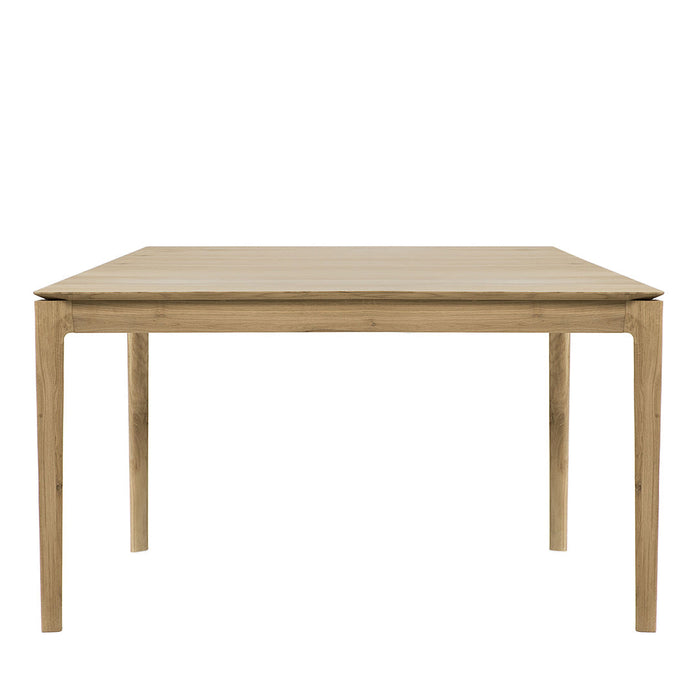 "Stylish square wooden dining table in light natural wood finish with smooth, minimalistic surface."
