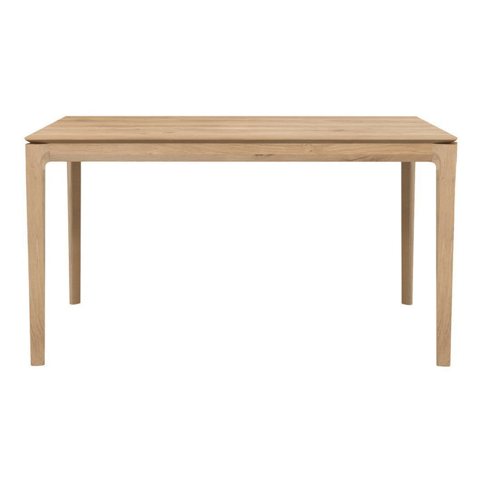 Natural wood finish dining table with a smooth surface and sturdy, minimalist design in light beige tones.