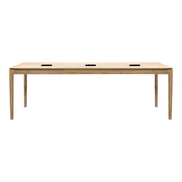 Natural wood dining table with a smooth finish and minimalist design featuring three embedded charging ports.