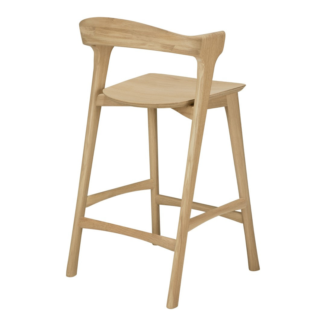 Natural wood bar stool in light oak finish with smooth contours and a simple, minimalist design.