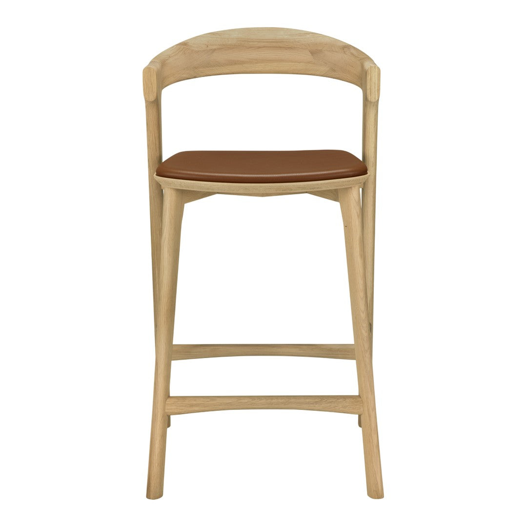 Natural wood frame with a light oak finish and a warm brown leather seat. Modern, minimalist design.