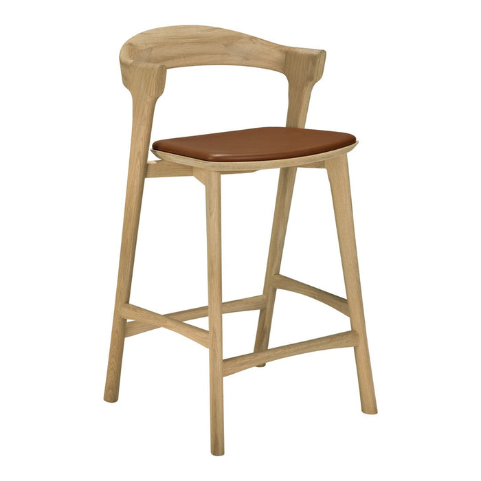 Natural wood bar stool with a light oak finish and a rich brown leather seat cushion. Sleek, modern design.