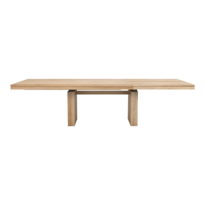 Natural wood dining table with a smooth, light oak finish and simple, modern design.