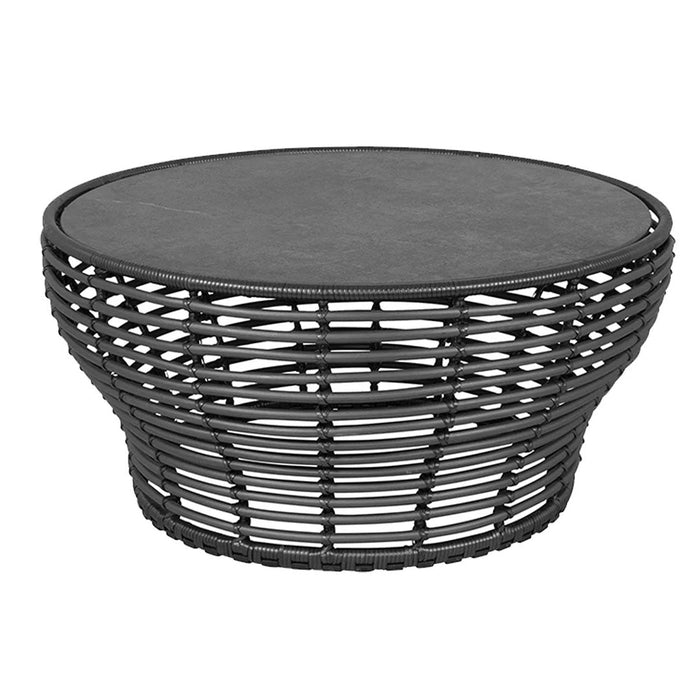 Black woven coffee table with a smooth gray top and intricate lattice pattern. Ideal for modern decor.