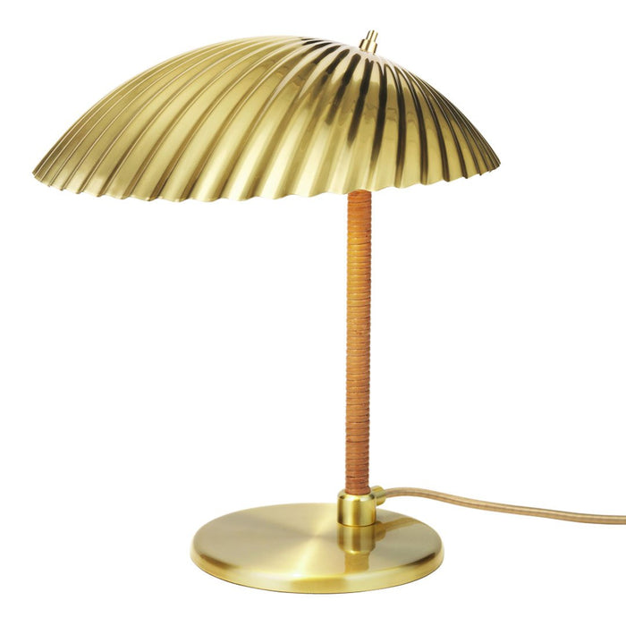 Gold ribbed lampshade on a sleek brass base with a woven cord accent, adding a touch of elegance to any space.