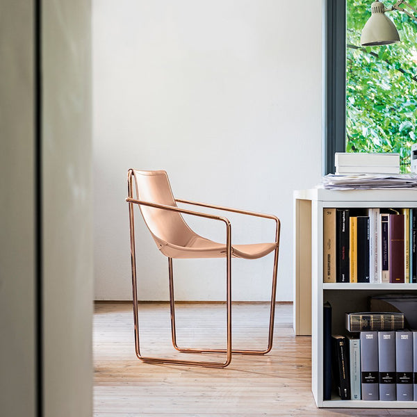 Stylish blush pink chair with sleek metal frame, perfect for modern decor. Minimalist design complements any space.
