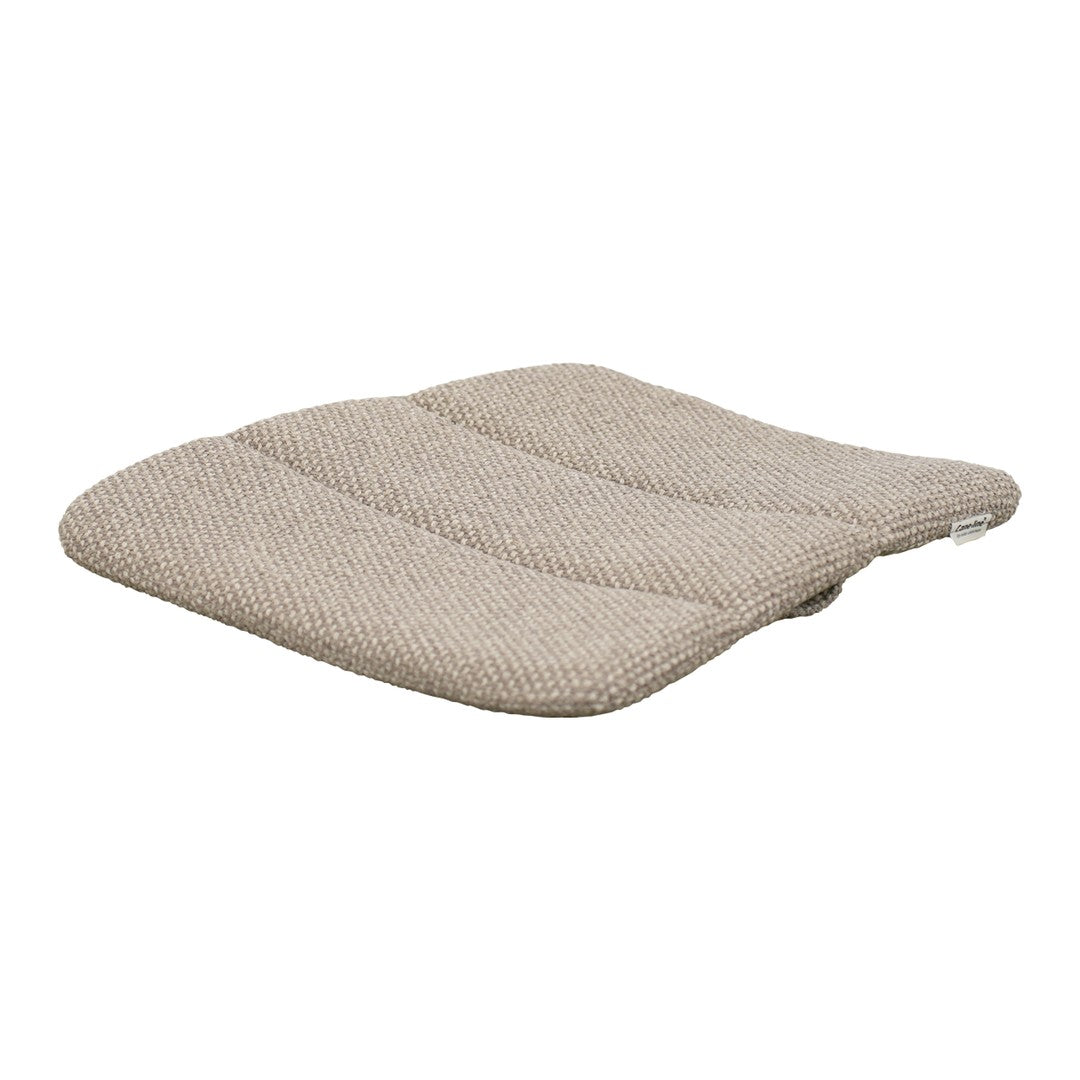 Beige cushion with subtle textured pattern and contoured shape for enhanced comfort and style. Perfect for any decor.