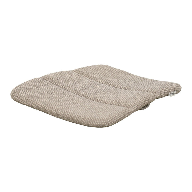 Beige cushion with subtle textured pattern and contoured shape for enhanced comfort and style. Perfect for any decor.
