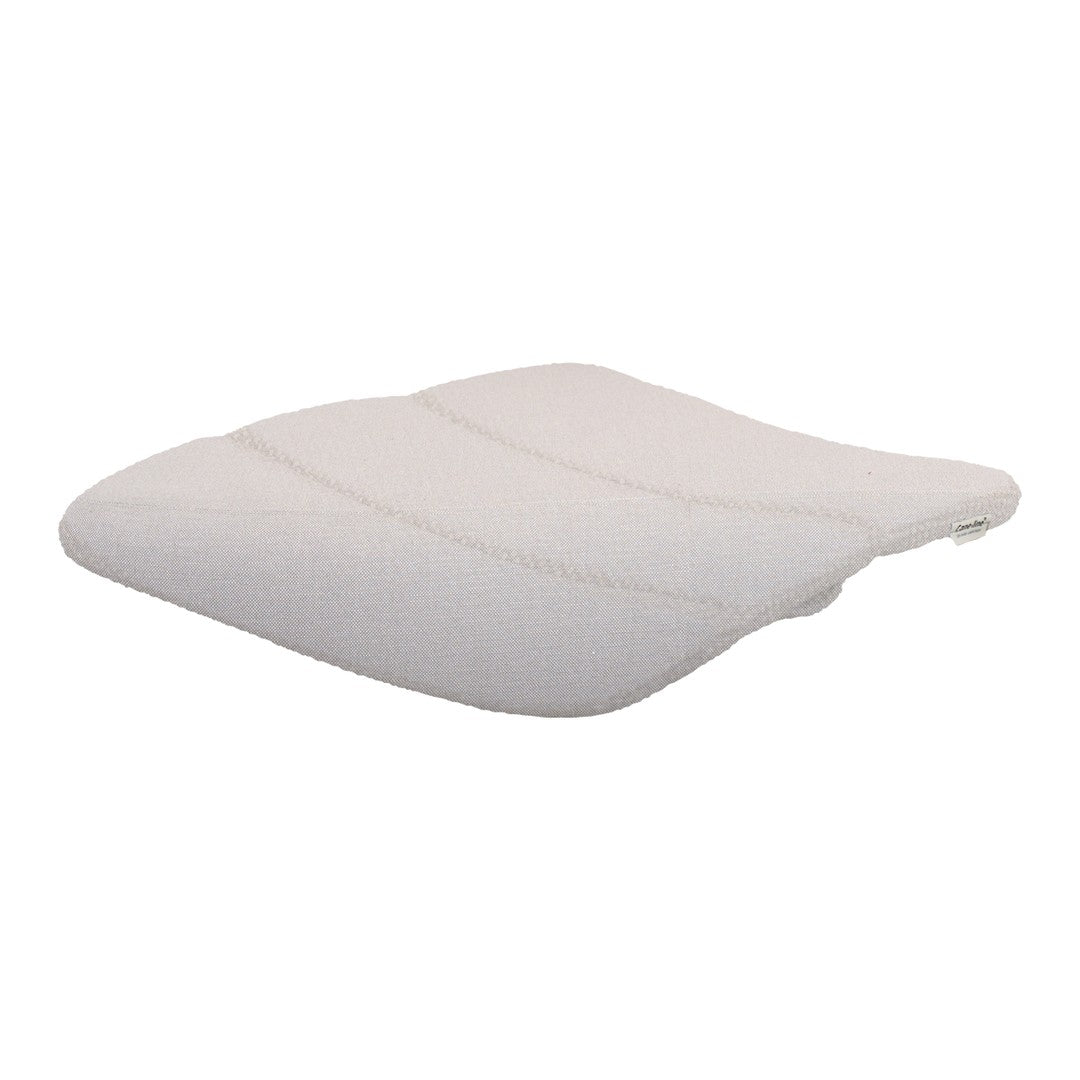Soft white cushion with a subtle quilted pattern, perfect for added comfort and style in any space.
