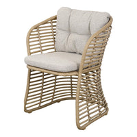 Light beige cushion on a woven natural rattan chair with a modern, curved design and open pattern. Perfect for outdoor decor.