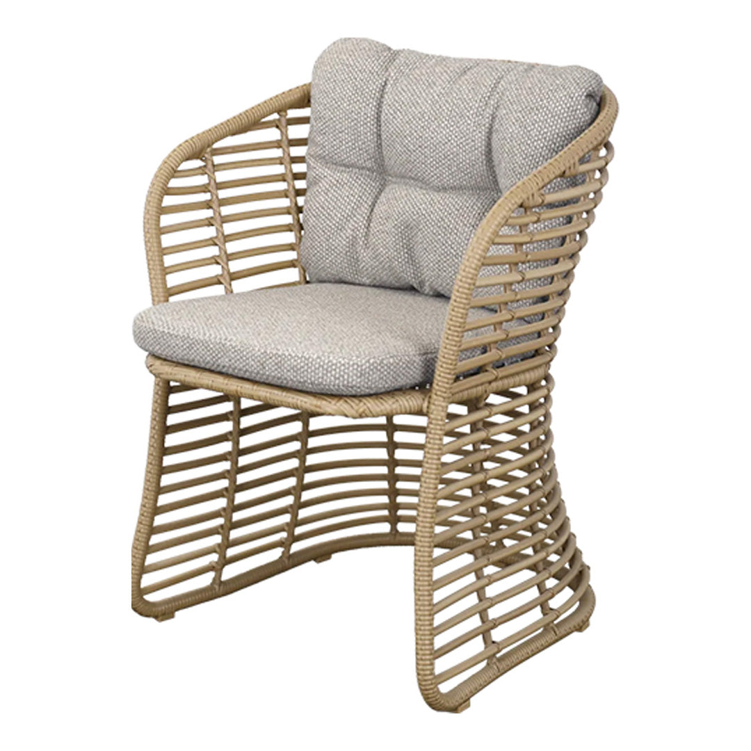 Beige woven chair with light gray cushions, featuring a modern, open pattern for a stylish touch.