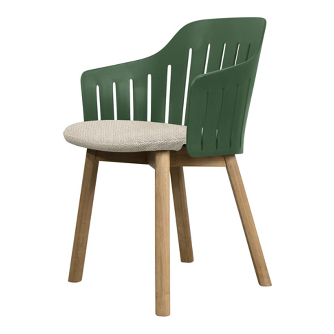 Green slatted back chair with beige cushioned seat and light wood legs, offering a modern and stylish design.