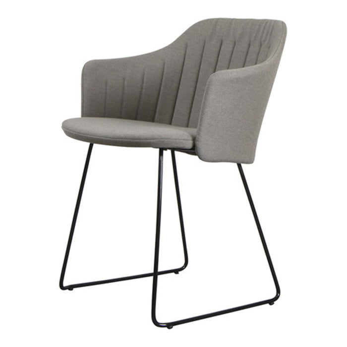 Gray upholstered chair with vertical ridges, set on a sleek black metal frame. Modern and stylish design.