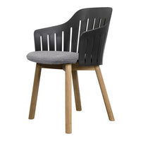 Modern black chair with vertical slats and gray upholstered seat, complemented by natural wood legs.