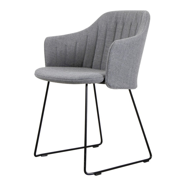 Gray upholstered chair with vertical ribbed pattern and sleek black metal legs. Modern and stylish for any space.