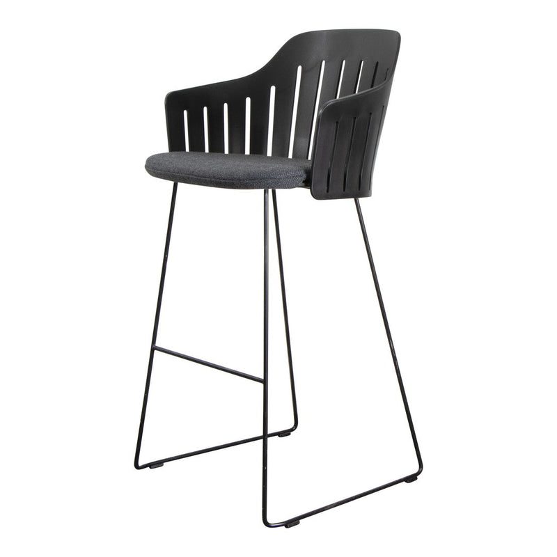 Black bar stool with a slatted backrest and gray cushioned seat, stylish metal legs for modern decor.