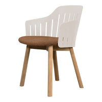 White slatted back armchair with a brown cushion and natural wood legs, showcasing a modern design and warm colors.