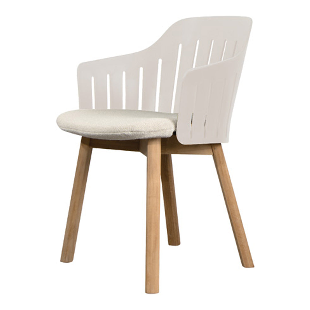 White slatted chair with a light cream cushion and natural wood legs, perfect for modern decor.