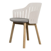 White slatted chair with a gray cushion and natural wood legs, perfect for modern interiors.