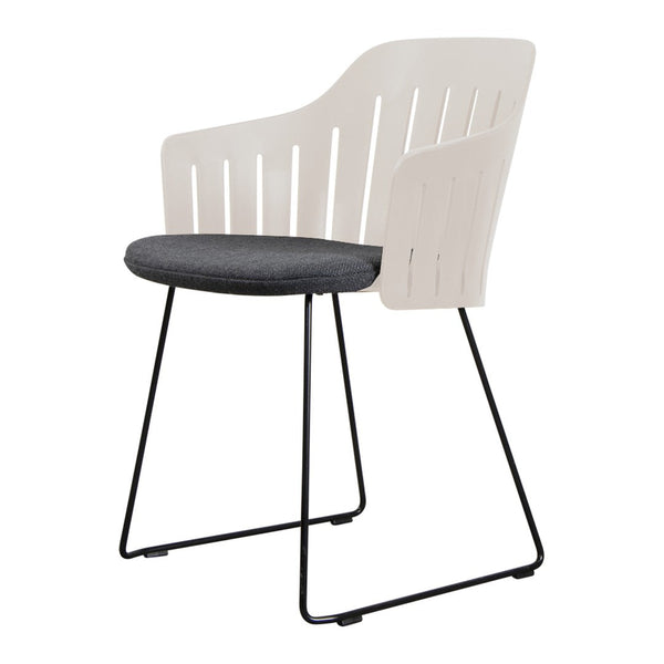 White slatted chair with a gray seat cushion on a black metal frame, showcasing a modern and minimalistic design.