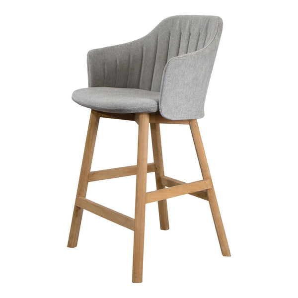 Gray upholstered bar stool with ribbed pattern and natural wood legs, perfect for modern interiors.