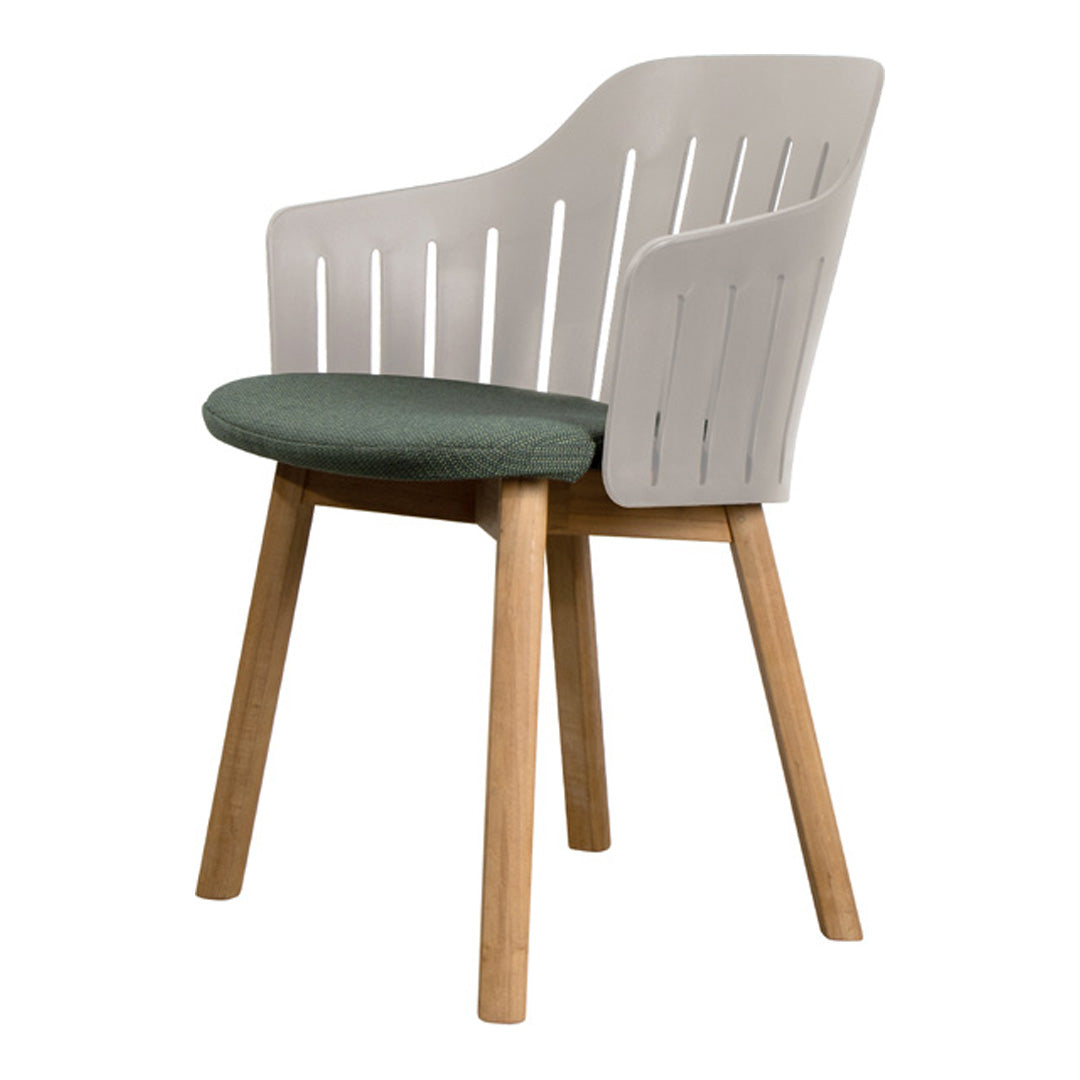 White chair with slatted back and green fabric cushion, natural wood legs for a modern and stylish look.