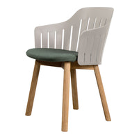 White chair with slatted back and green fabric cushion, natural wood legs for a modern and stylish look.
