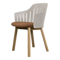 White and wooden chair with a brown upholstered seat and slatted back design, perfect for modern interiors.