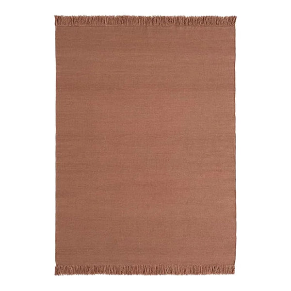 Rust-colored woven rug with a subtle texture and fringed edges, perfect for adding warmth to any space.